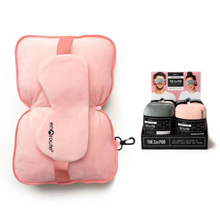 Pink travel pillow with matching eye mask and clip, featuring soft fabric and compact design that zips closed 
