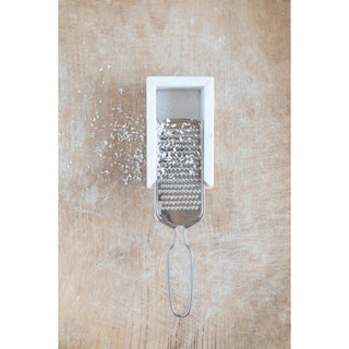 Marble and stainless steel handheld grater with white marble tray