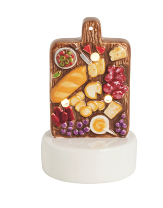 Hand-painted ceramic Charcuterie Light-Up Sitter featuring a charcuterie board with cheese, grapes, bread, salami, olives, and LED lights on a white display base.