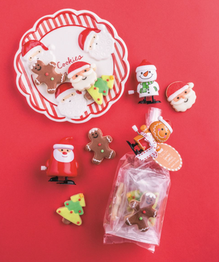 "Christmas sugar cookie gift set with wind-up toy"

"Holiday cookie set with Santa, snowman, and gingerbread designs"

"Festive Christmas cookie pack with toy and ribbon"

"Pack of iced sugar cookies and wind-up Christmas toy"


