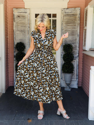 Tatum Dress in a navy floral print featuring a front zip neckline, smocked waist, drop shoulders, midi length, and side pockets.