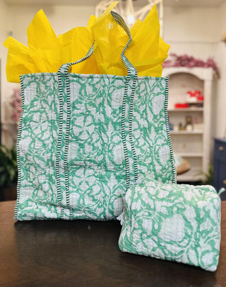 Green Gardenia quilted tote bag with matching makeup pouch

Quilted green floral tote bag with striped handles and zipper pouch

Green floral quilted tote bag filled with yellow tissue paper

Lightweight quilted tote bag with botanical print and makeup bag